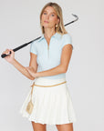 Cream Pleated Golf skirt paired with Sky Blue Short sleeve Body suit