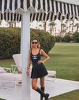 Be bold with Goldie Byrd's black pleated golf skirt